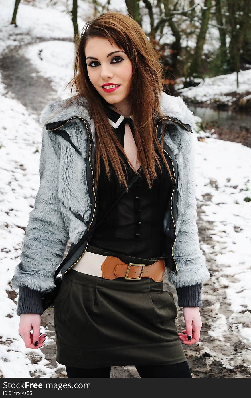 Female model standing in the woods on a cold snowy day. Female model standing in the woods on a cold snowy day