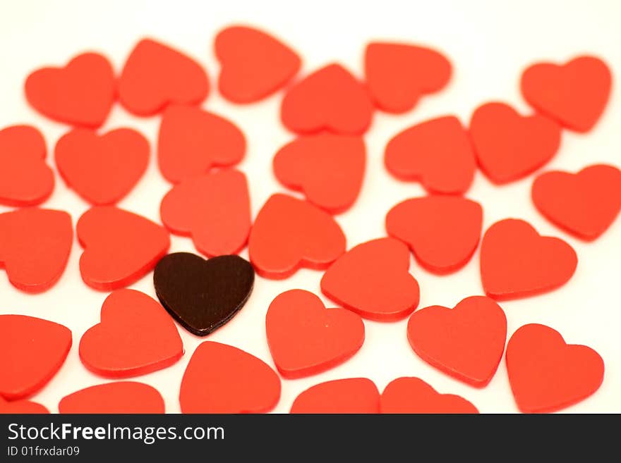 Black heart with a lot of small wooden hearts put on white background. Black heart with a lot of small wooden hearts put on white background