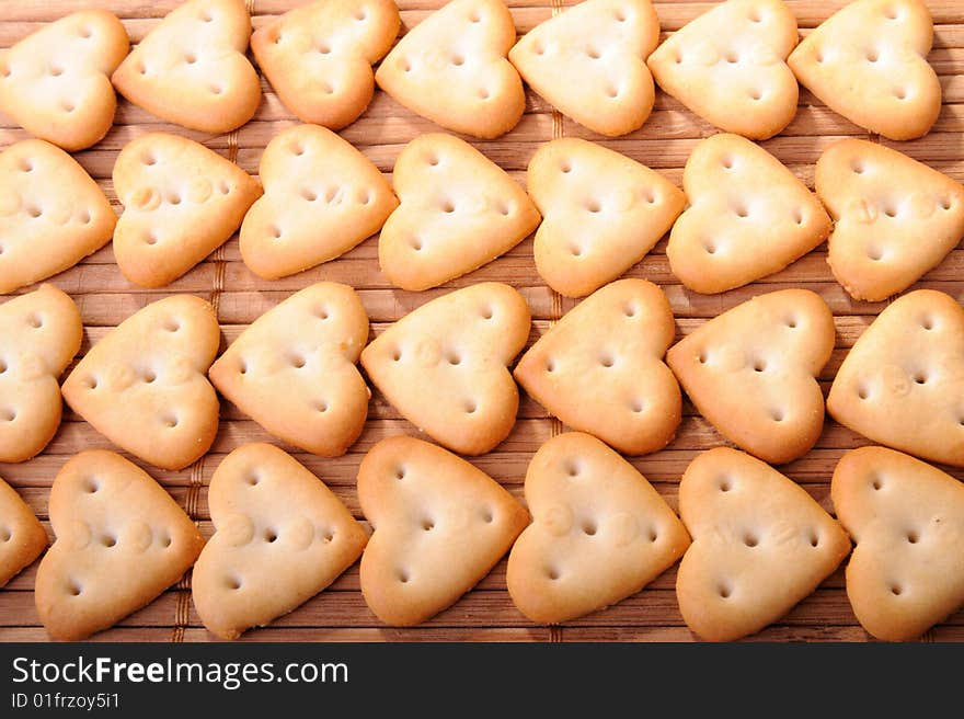 Rows of heart shaped cheese biscuits. Rows of heart shaped cheese biscuits