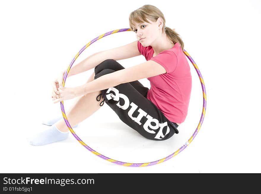 A young girl dealing with a sports hoop. A young girl dealing with a sports hoop