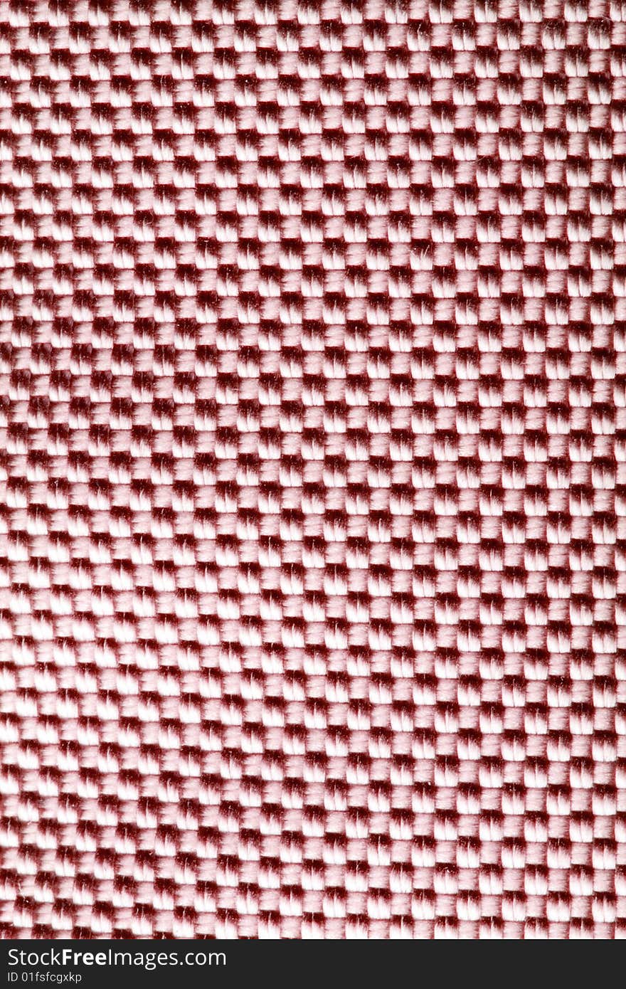 A close-up of the texture of red nylon fabric. A close-up of the texture of red nylon fabric