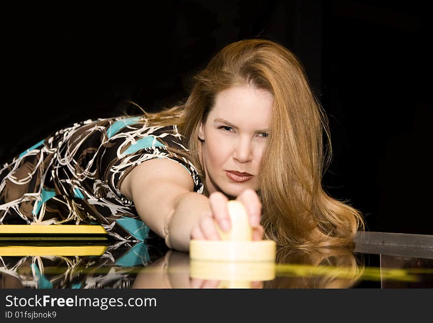 Woman with Serious Expression While Playing Air Hockey Game. Woman with Serious Expression While Playing Air Hockey Game