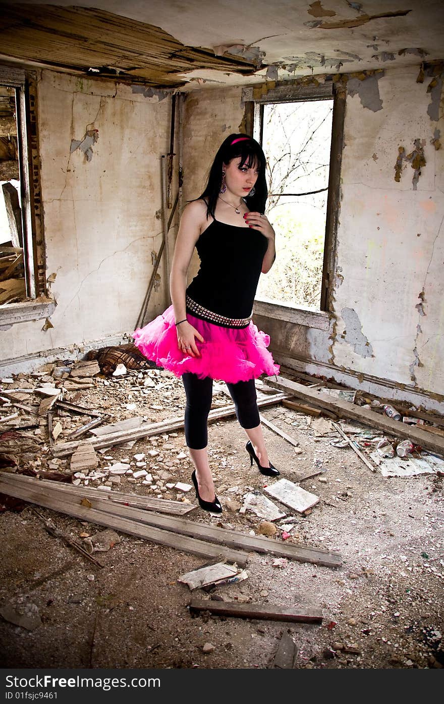 Pretty young woman wearing a pink tutu in an abandoned building. Pretty young woman wearing a pink tutu in an abandoned building