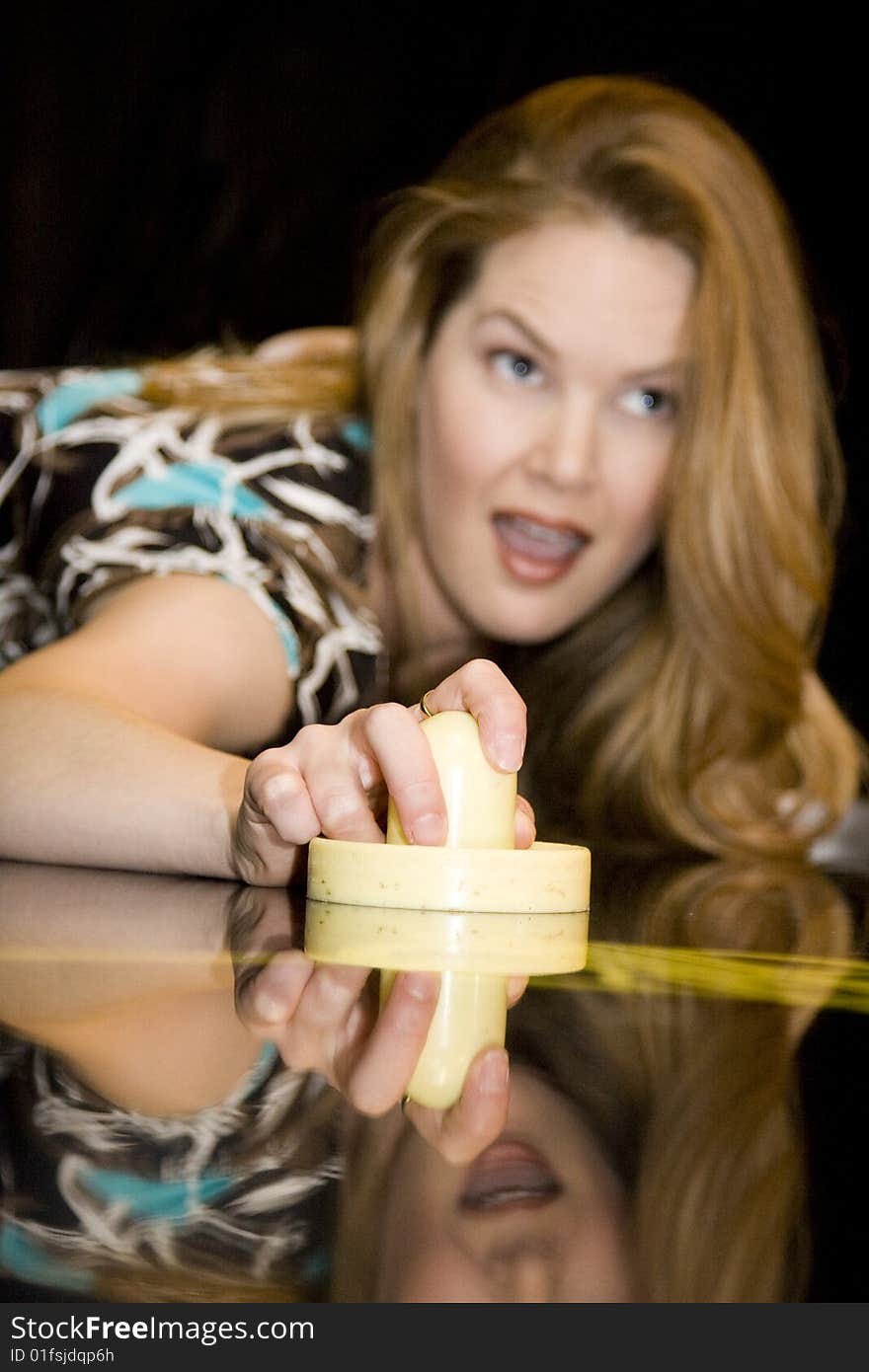 Young Woman Holding Air Hockey Mallet