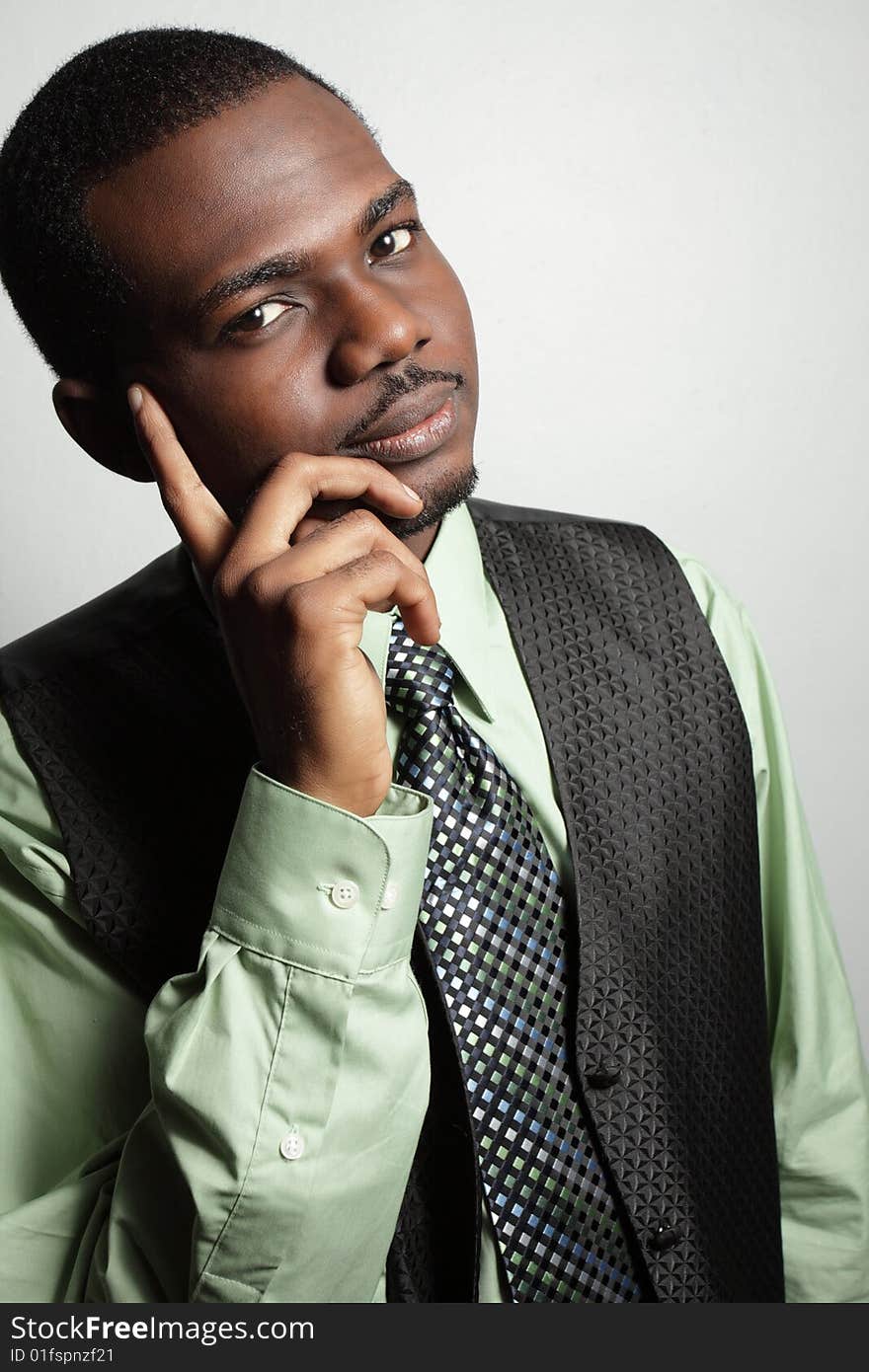 Young businessman posing with his hand on his face. Young businessman posing with his hand on his face