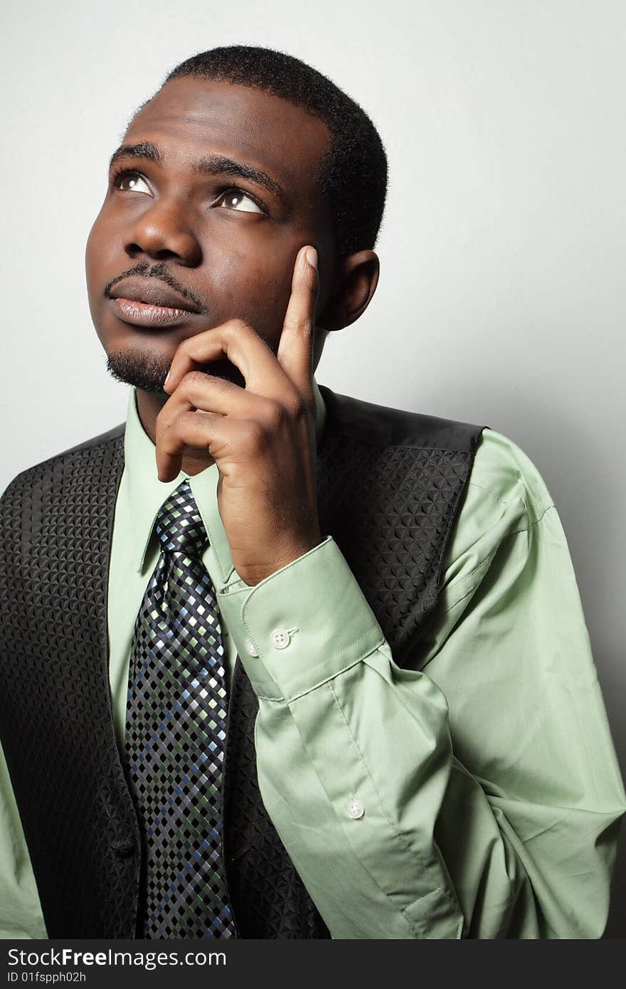 Young businessman posing with his hand on his face. Young businessman posing with his hand on his face