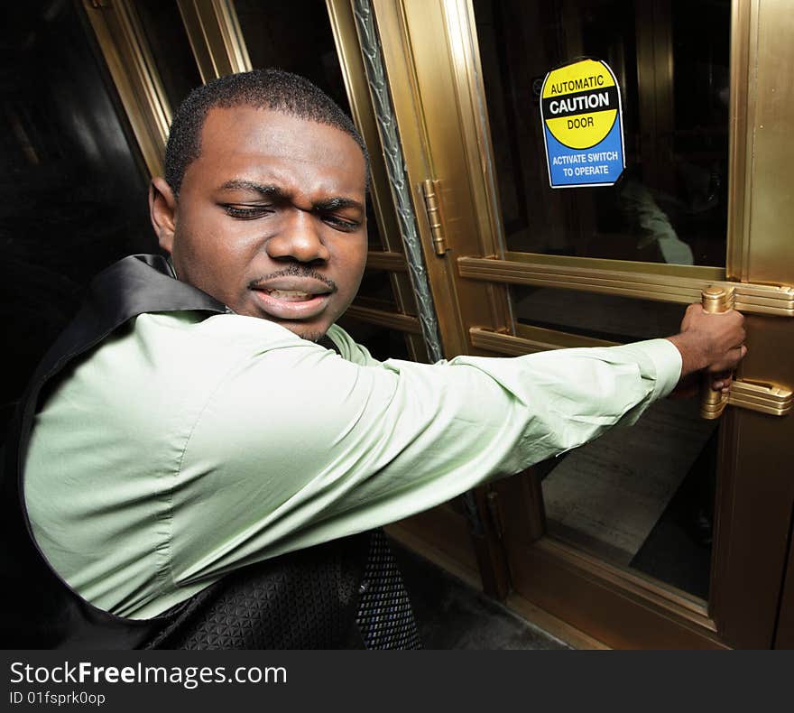 Businessman trying to open an electronic door. Businessman trying to open an electronic door