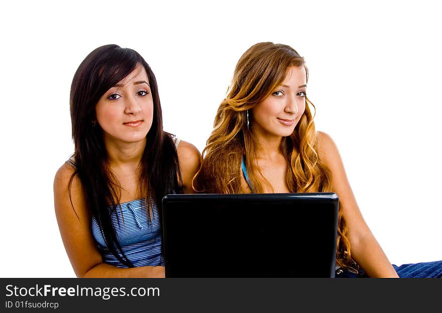 Portrait of young female students with laptop against a white background