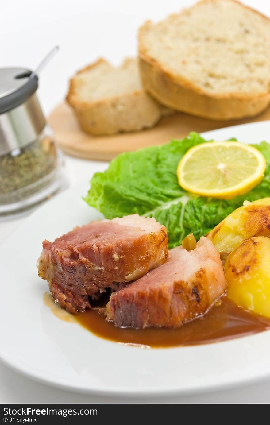 Roasted Slices Of Pork With Lettuce And Fried Pota