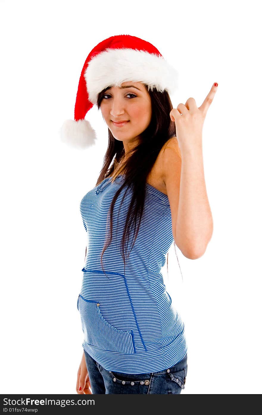 Side view of pointing girl with christmas hat against an isolated background