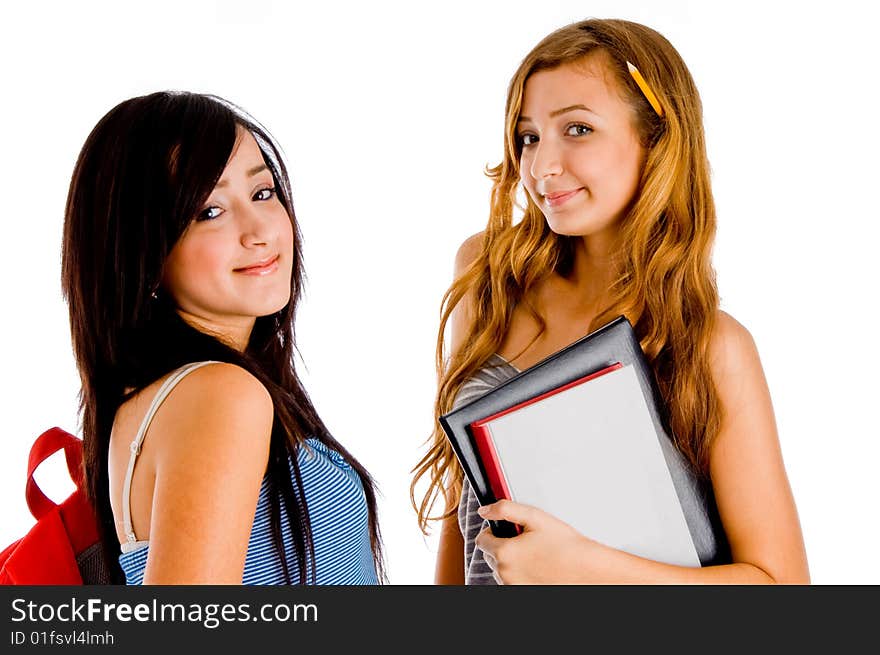 Smiling students posing with bag and books on an isolated white background