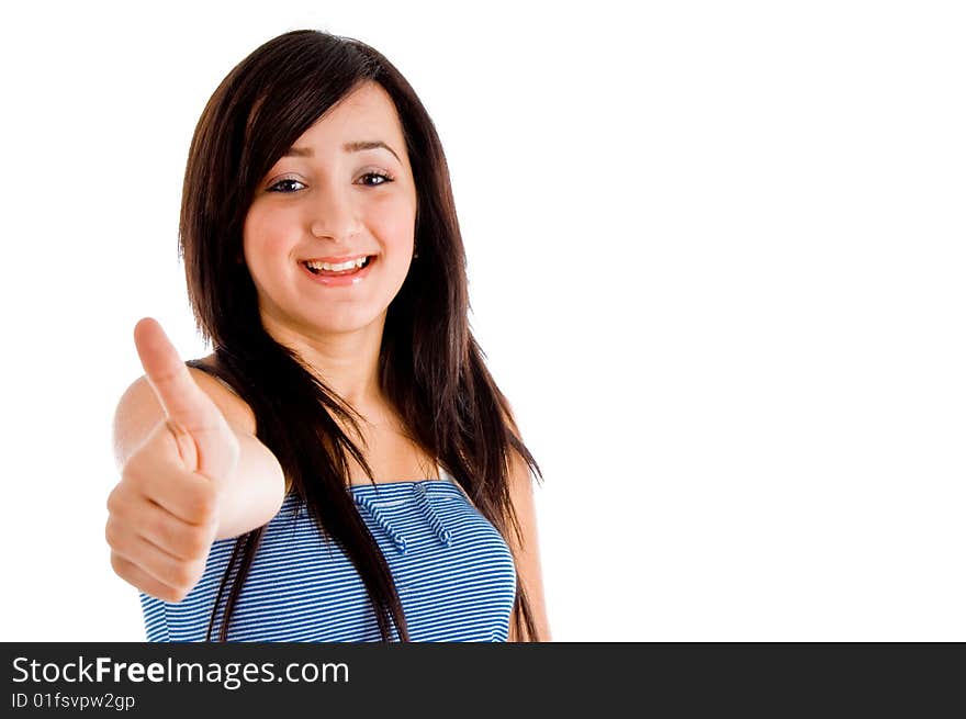 Smiling young girl showing you thumb up against white background. Smiling young girl showing you thumb up against white background