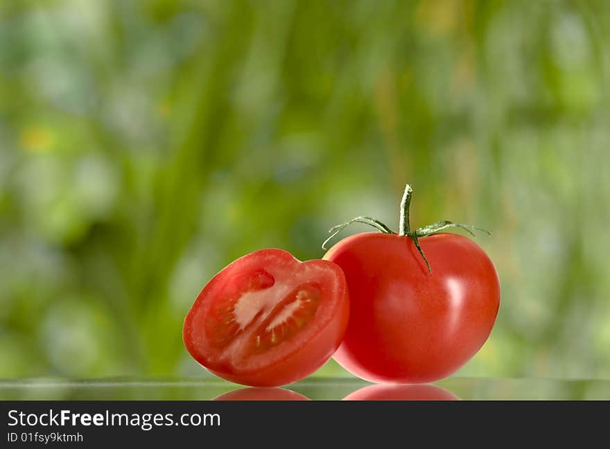 Close up view of nice red fresh tomato on green  back. Close up view of nice red fresh tomato on green  back