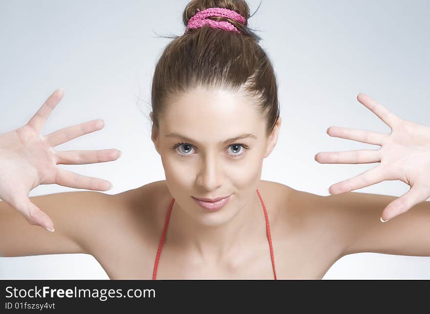 High key portrait of young woman on gray  back