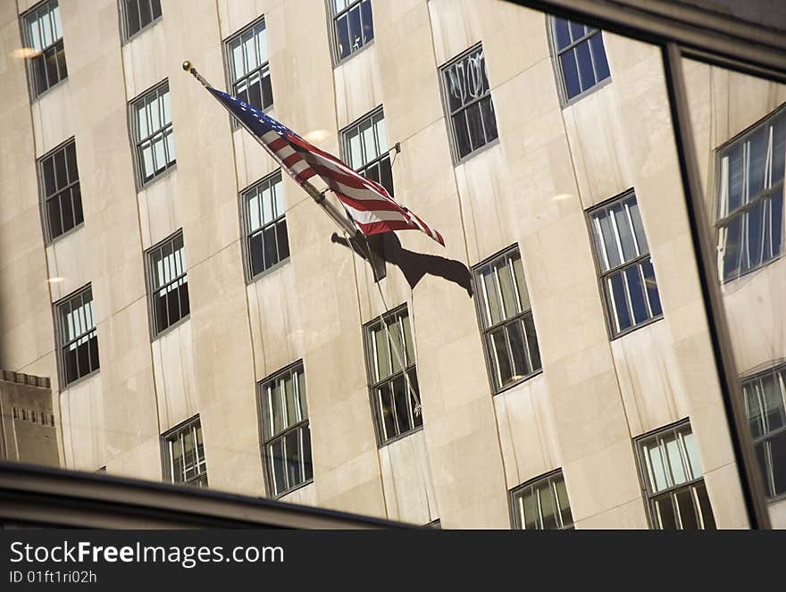 USA flag reflectod on a window at NYC