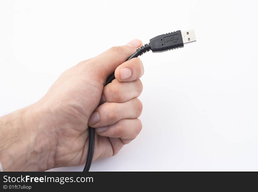 Hand with black cable on white background