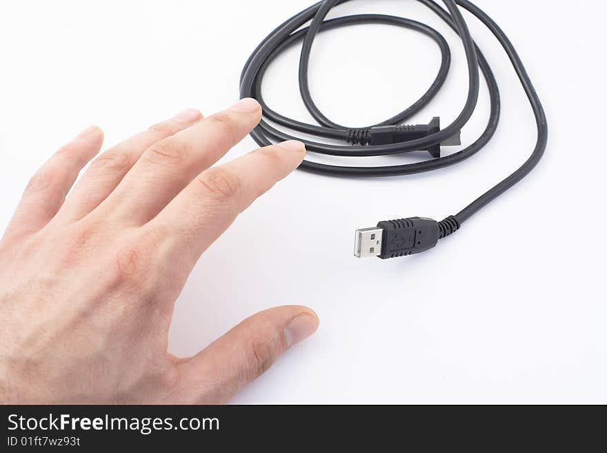 Hand and black cable on white background