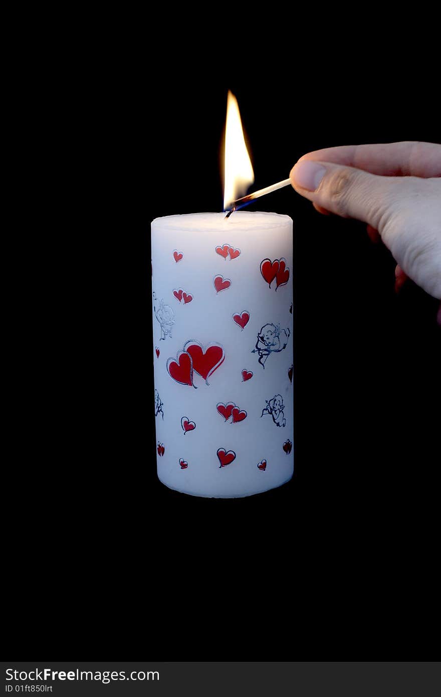 Candle with flame and black background