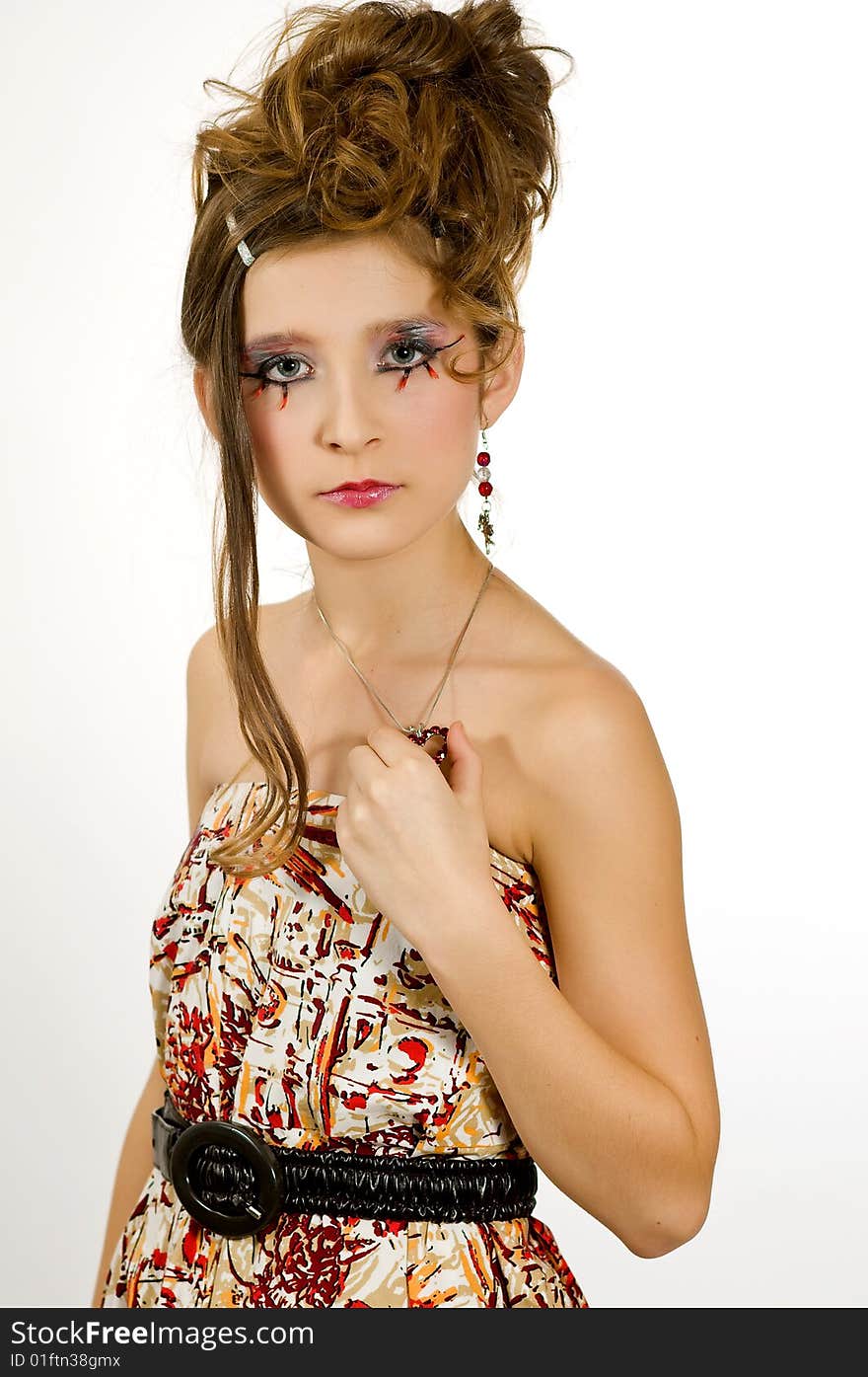 Closeup of young fashion girl with special eye makeup wearing colored top and black belt