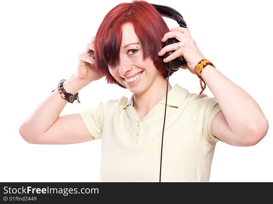 Isolated smiling young girl listening to music. Isolated smiling young girl listening to music