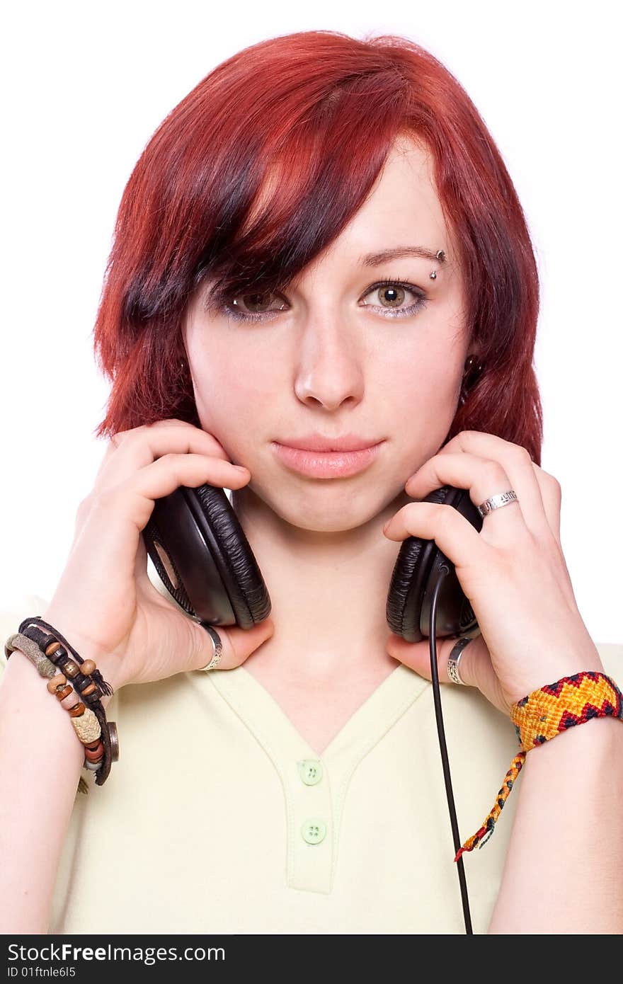 Isolated smiling young girl listening to music. Isolated smiling young girl listening to music