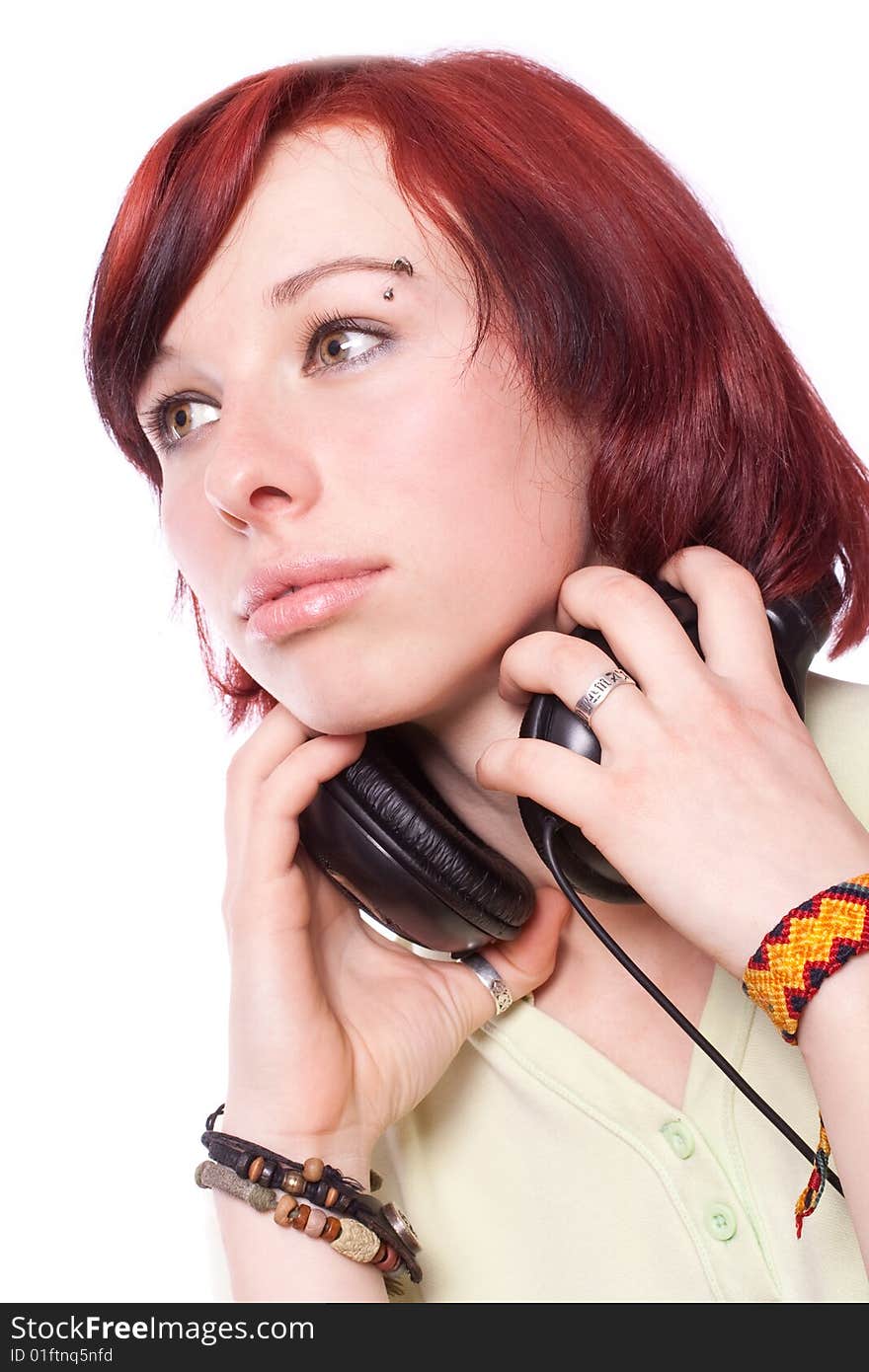 Isolated smiling young girl listening to music. Isolated smiling young girl listening to music