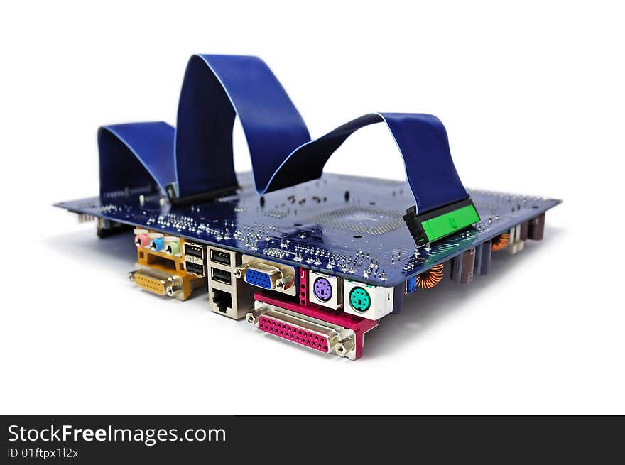 A computer motherboard with IDE cable on top on white background. Computer assembling concept. A computer motherboard with IDE cable on top on white background. Computer assembling concept.