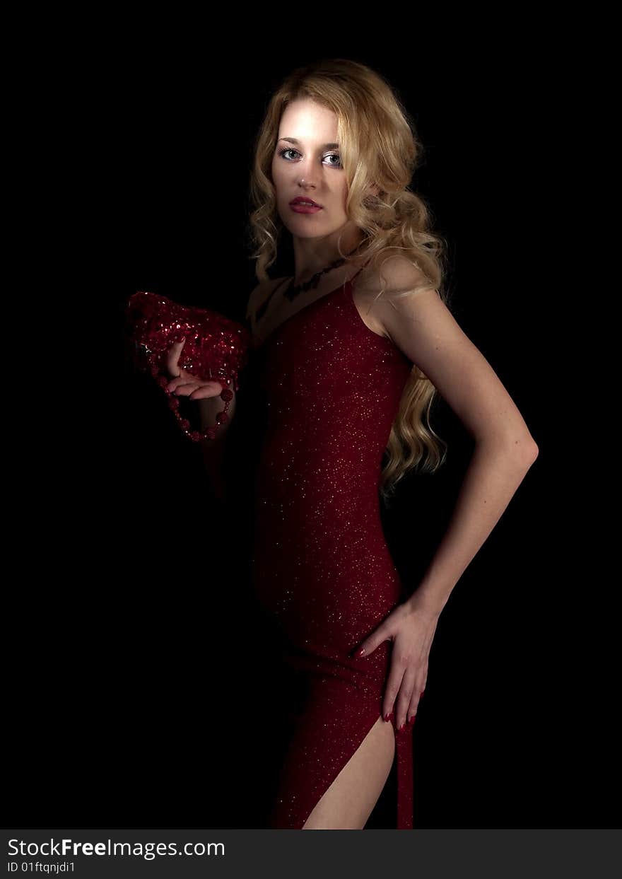 Beautiful blonde young lady in red dress on black background. Beautiful blonde young lady in red dress on black background