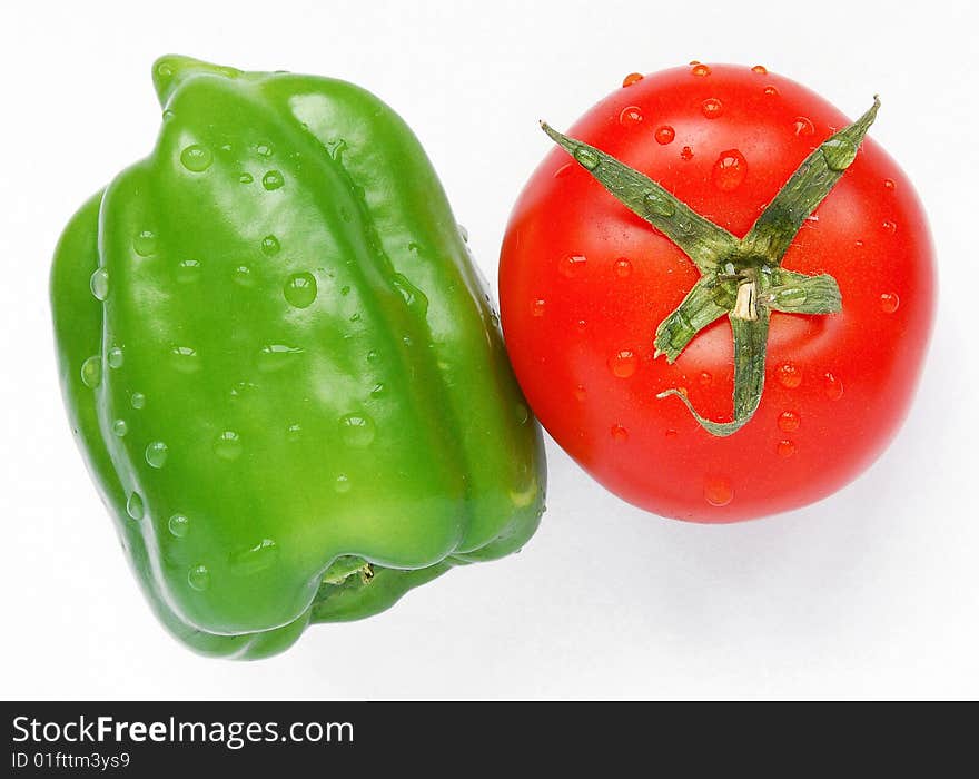 Green Pepper and Red Tomato on White Background. Green Pepper and Red Tomato on White Background