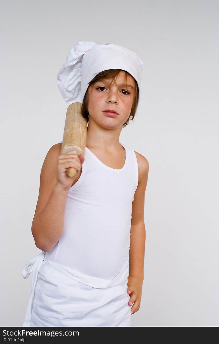 Young baker boy holding a rolling pin