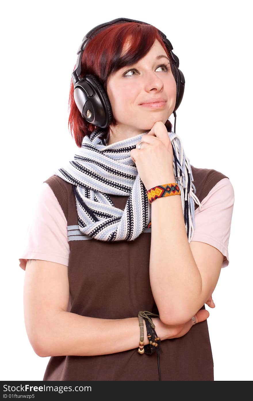 Isolated smiling young girl listening to music. Isolated smiling young girl listening to music