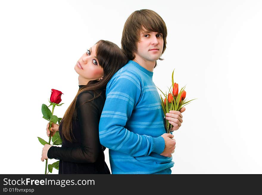 Young couple with rose and tulips, isolated on white background