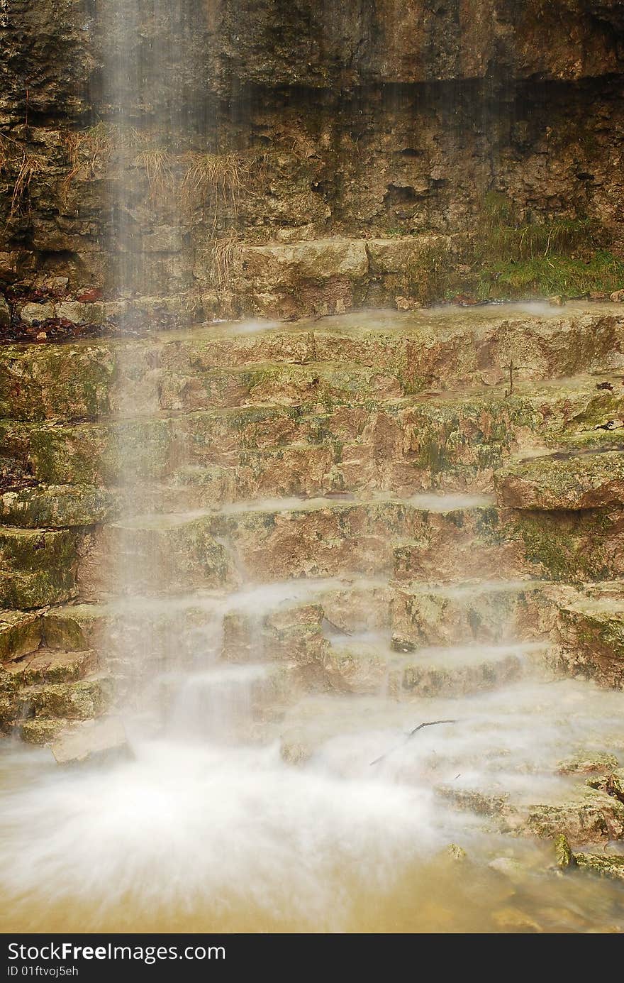 This image is of a natural waterfall at a local state park. The wall behind the falls form steps at the base of the falls. this image shows the steps behind the falls. This image is of a natural waterfall at a local state park. The wall behind the falls form steps at the base of the falls. this image shows the steps behind the falls.