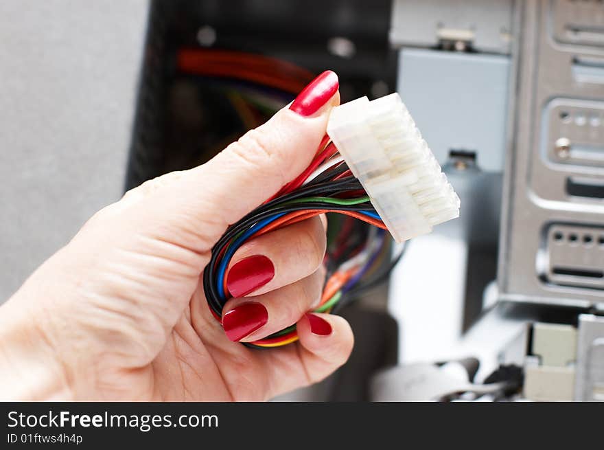 Woman hand assembles computer cable