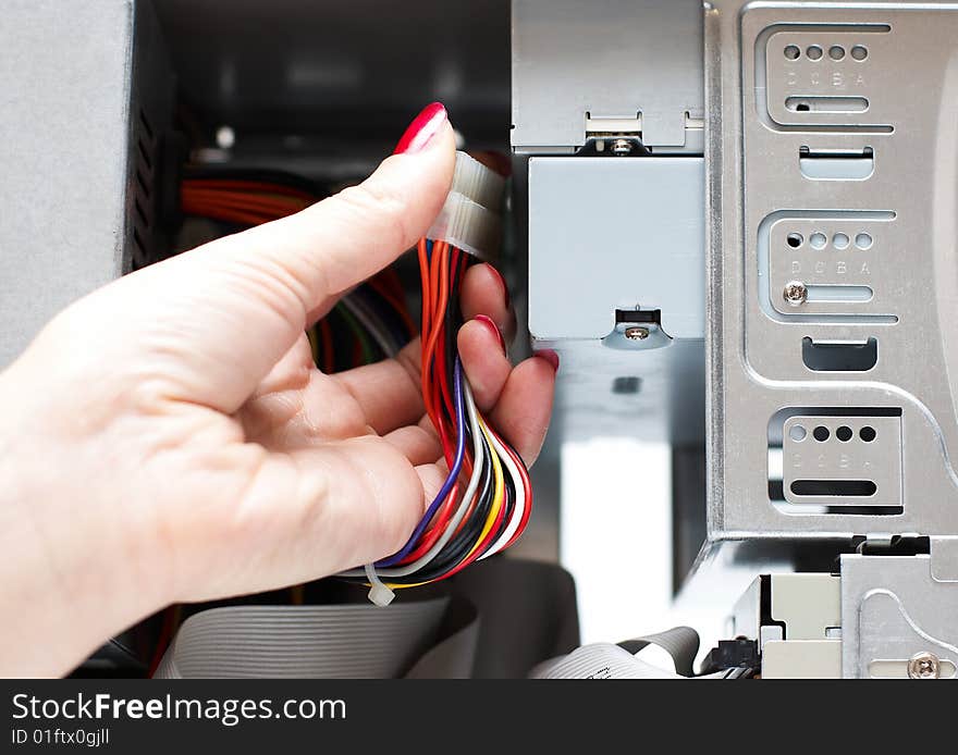 Woman hand assembles computer cable