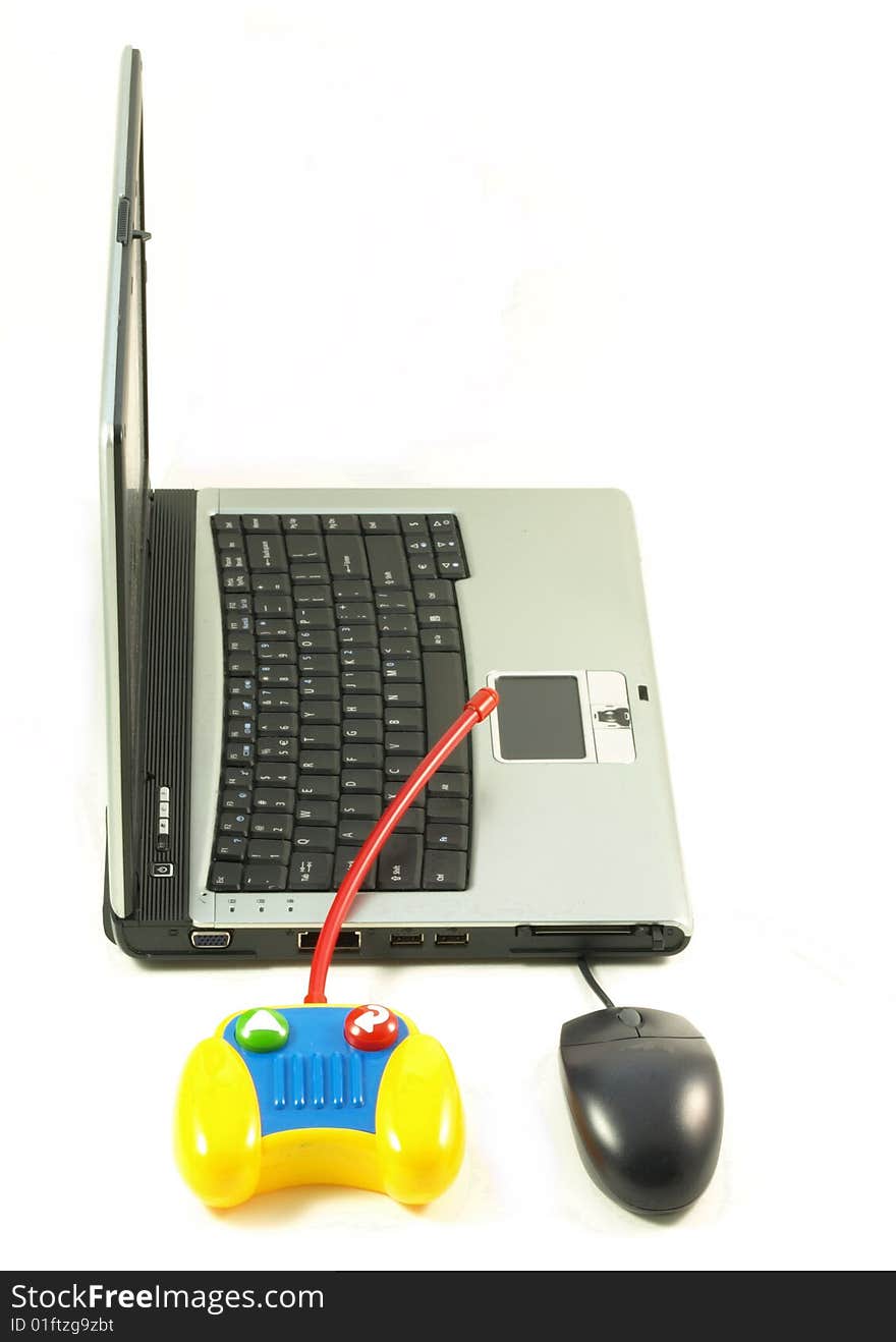 Laptop, mouse and a toy on white studio isolated background. Laptop, mouse and a toy on white studio isolated background.