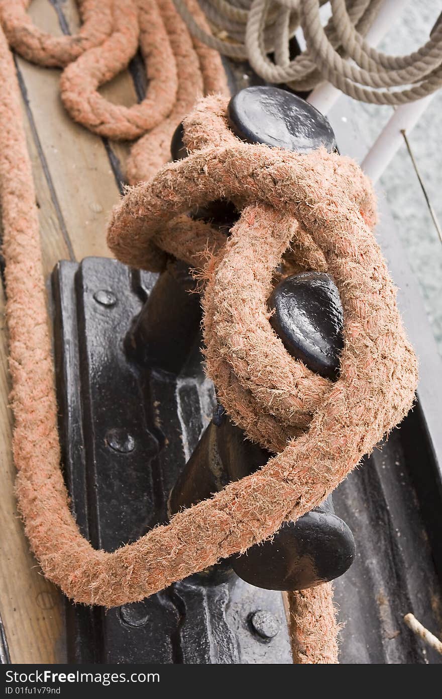 Large rope tied down to deck of tall ship. Large rope tied down to deck of tall ship