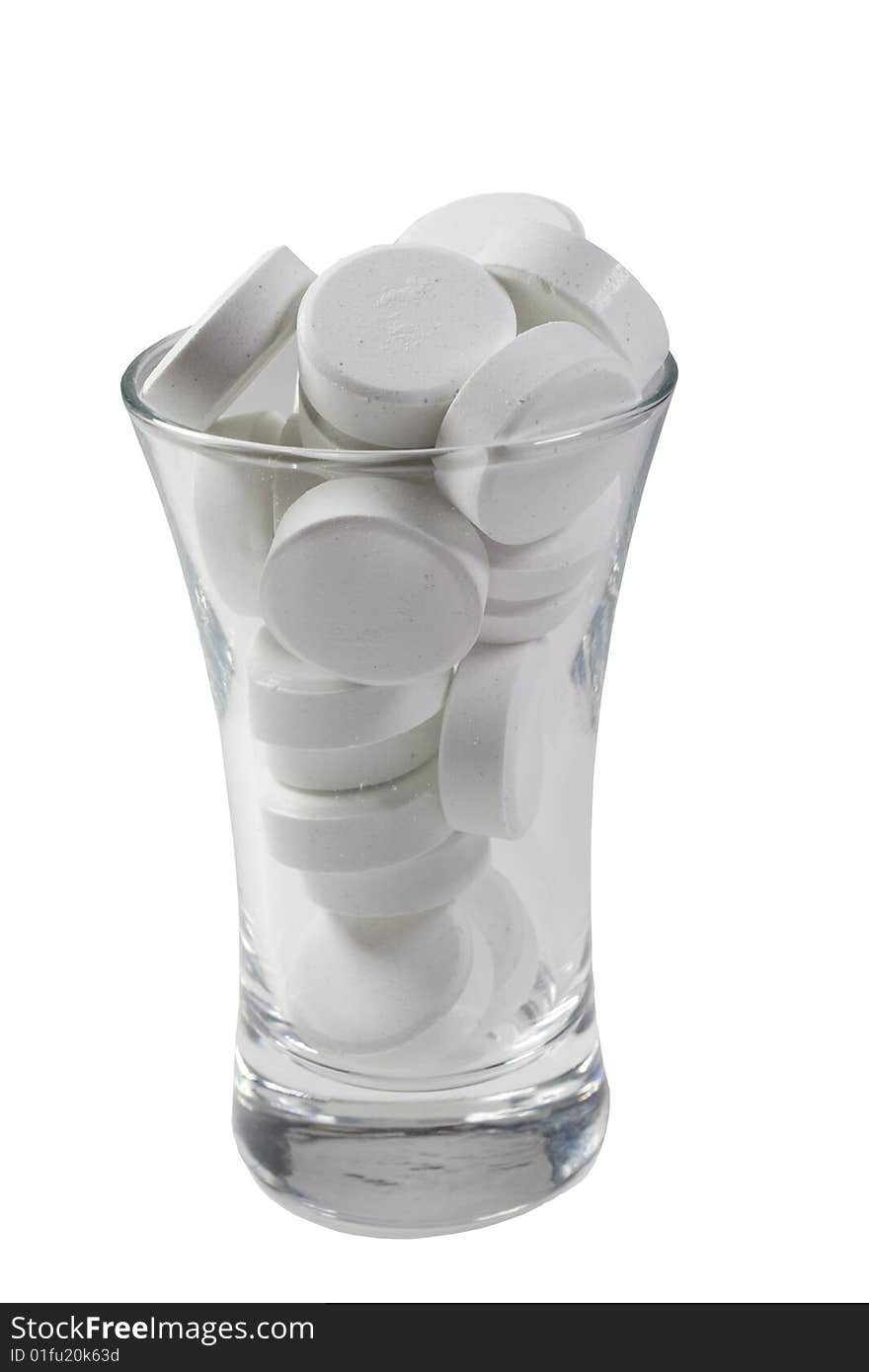 Glass full of pills (isolated on white)