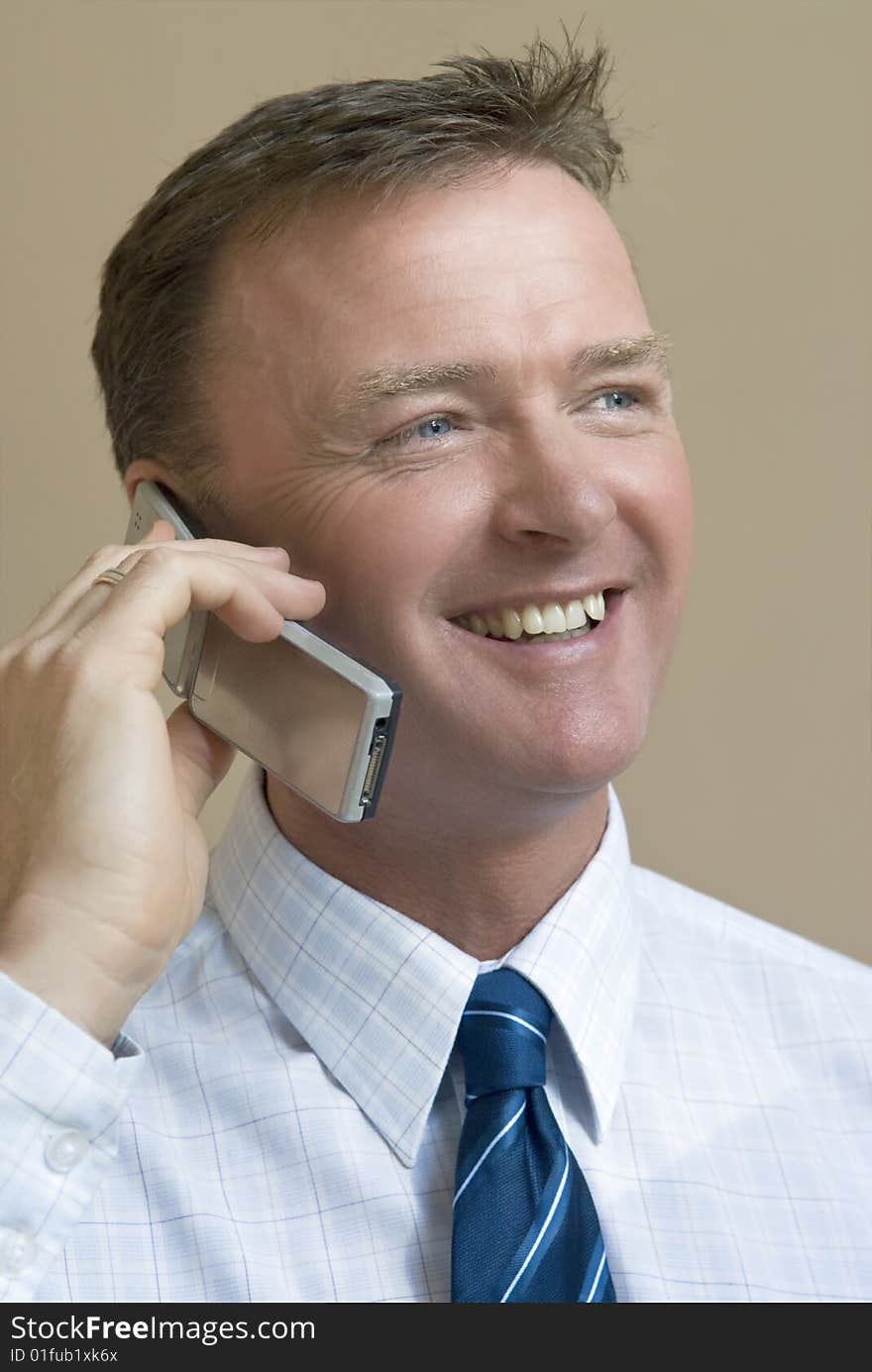 Happy smiling businessman on phone