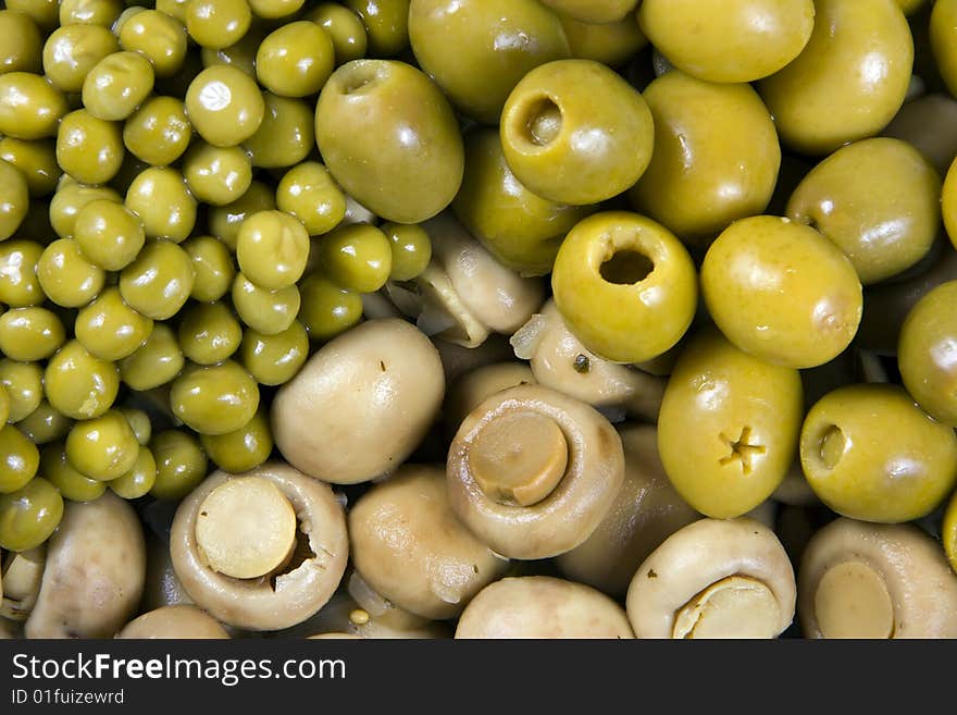 Background from olives, mushrooms and a green peas