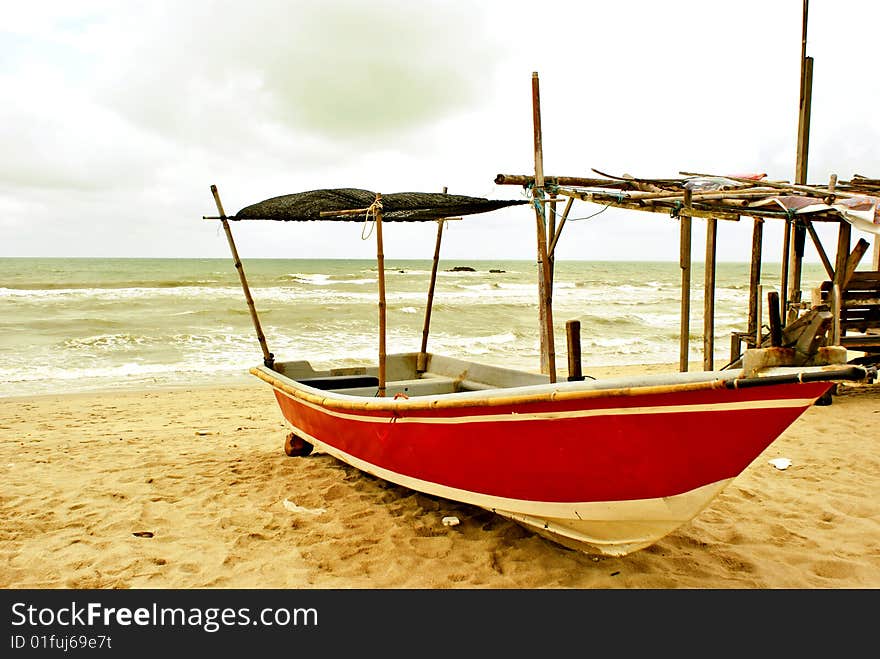 A wooden Malay fishing boat docked at the beach. See other similar images in my portfolio. A wooden Malay fishing boat docked at the beach. See other similar images in my portfolio.