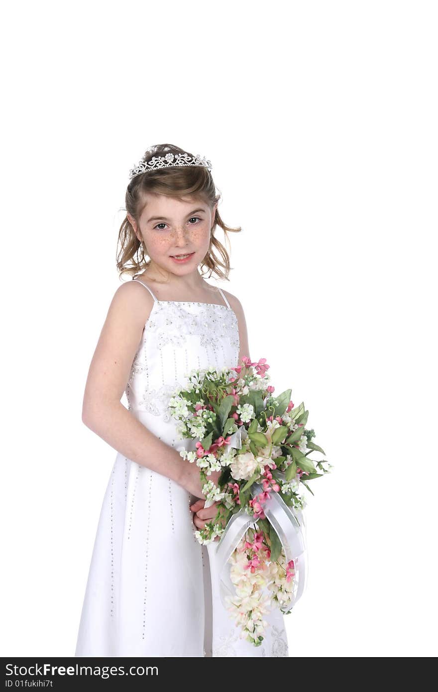 Pretty little girl in white gown, tiara, and holding a bouquet of flowers. Pretty little girl in white gown, tiara, and holding a bouquet of flowers