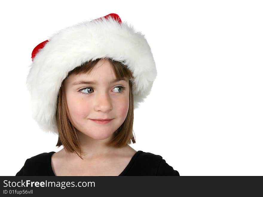 Cute girl in Santa hat, looking to the side at the copy space available