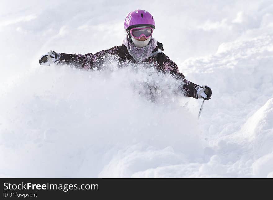 Girl riding on skis in the powder snow. Girl riding on skis in the powder snow