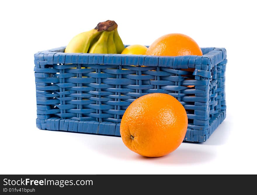 Blue basket with fruits on white background