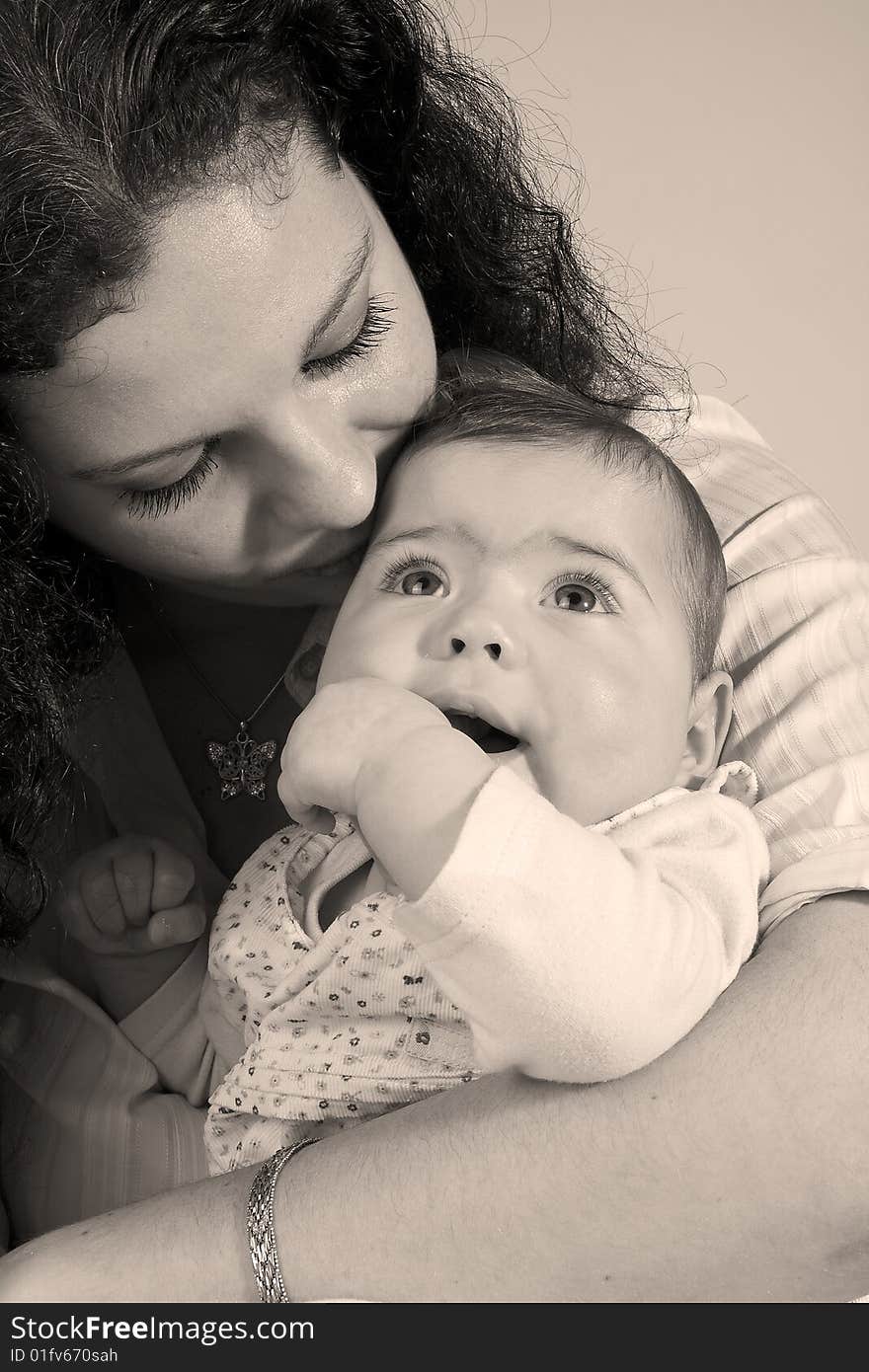 A mother that is holding her baby tenderly. A mother that is holding her baby tenderly