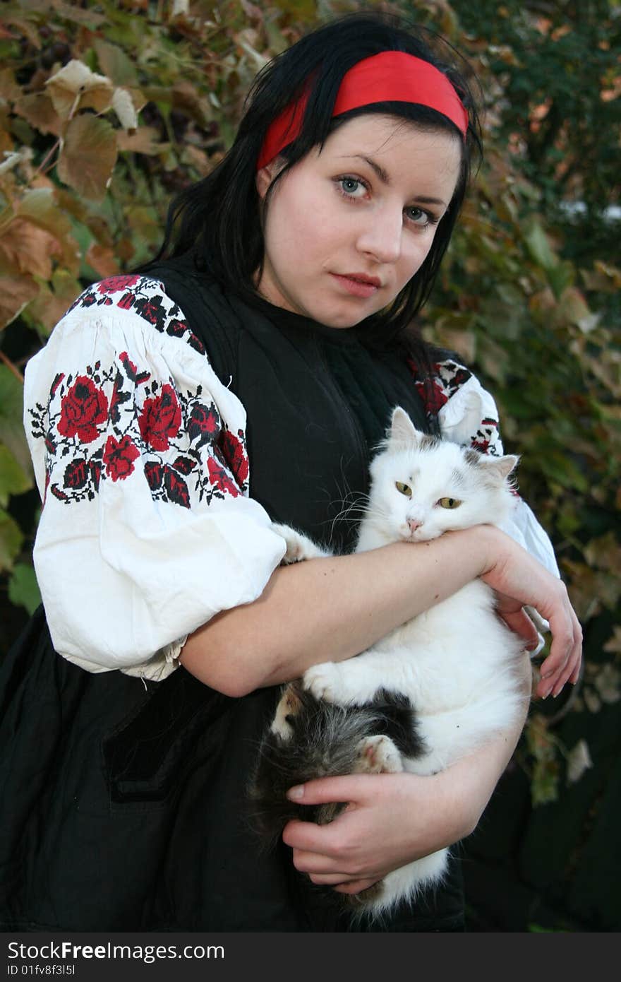 Village girl with a cat in Ukrainian clothes