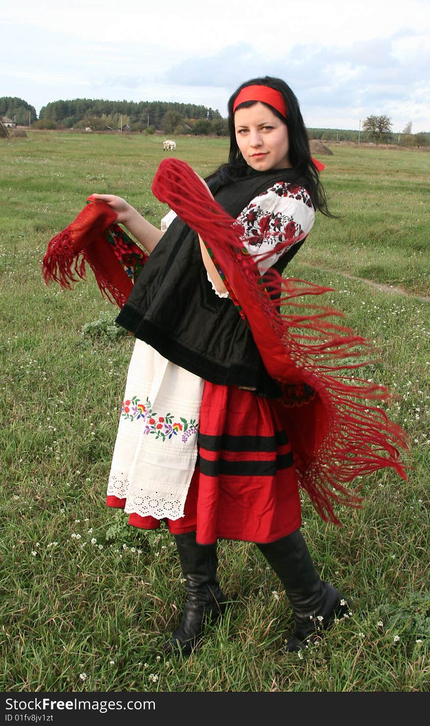 Village girl with a red scarf on field