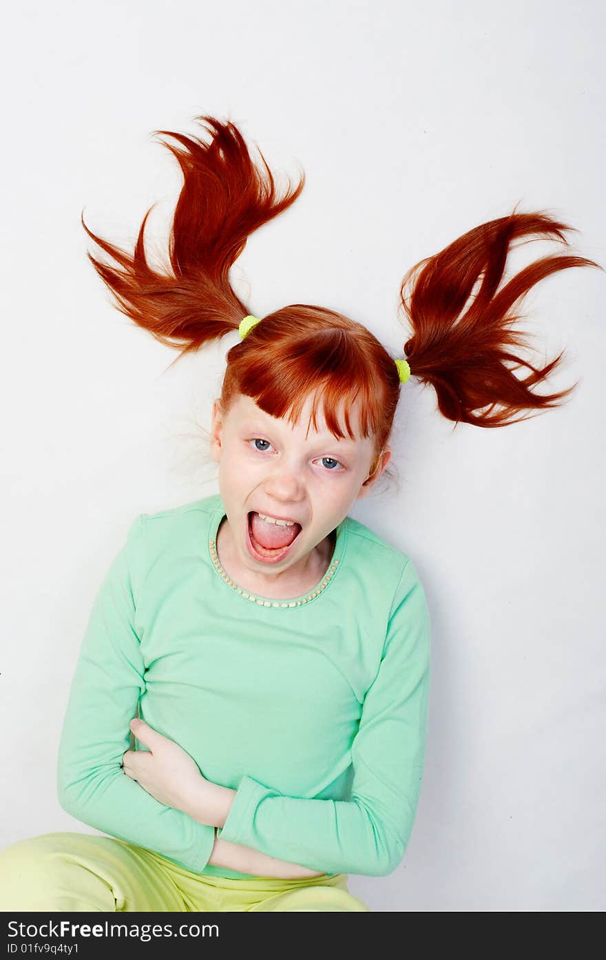 The girl loudly shouts. Photo on a white background.