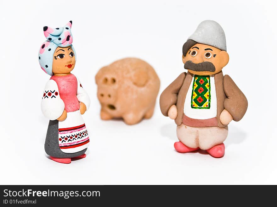 Man, woman and pig. Clay sculptures. National character, clothes, symbolism. Man, woman and pig. Clay sculptures. National character, clothes, symbolism.